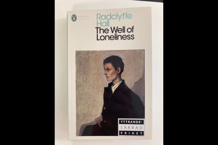 Bild som visar boken The well of lonliness. Omslaget föreställer en tavla av en androgyn person i kostym.