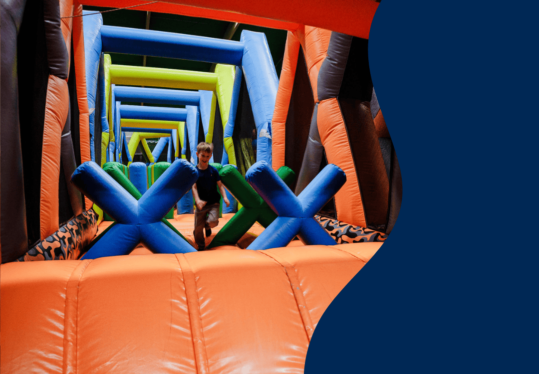 A young person in an inflatable obstacle course.