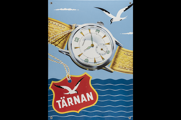 Reklambild med illustration av armbandsur. I bilden finns ett emblem där det står "Tärnan". I illustration syns även havet och en vit fågel.