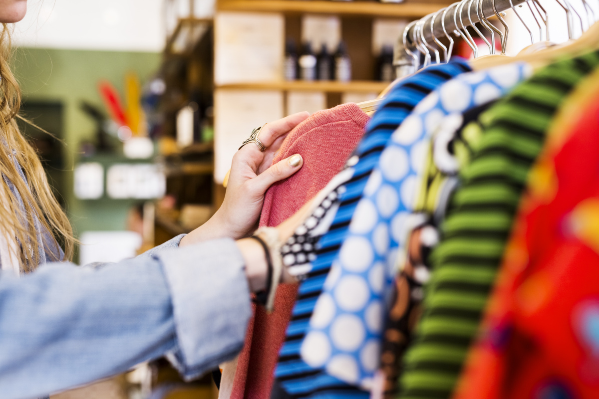 En person tittar på kläder i en butik