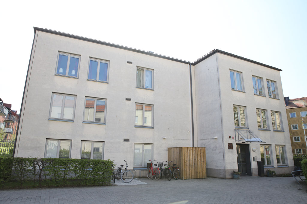 Den vita stilrena fasaden lyser upp kvarteret.