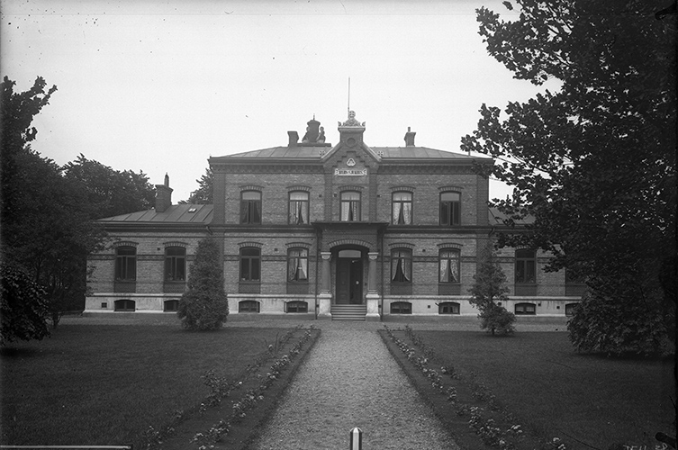 Äldre svartvitt foto på barnsjukhuset i parkmiljö.