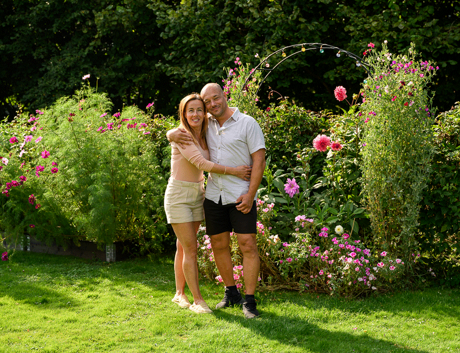 Emma Aldin och Rickard Lundqvist vid blomsterportalen i trädgården