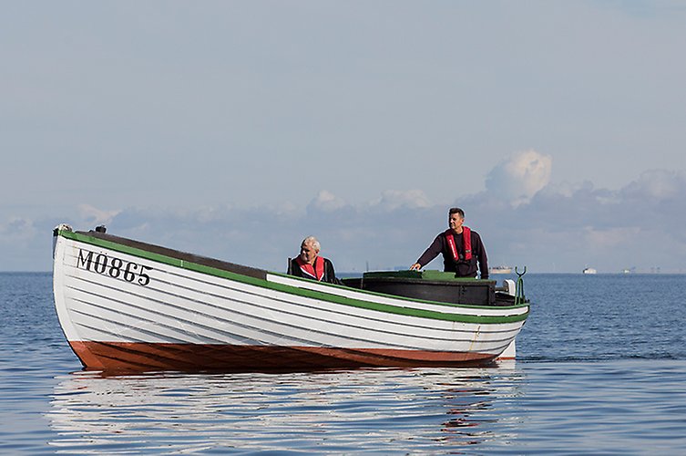 Bild på båten "Kalle" på Öresund med passagerare ombord. 